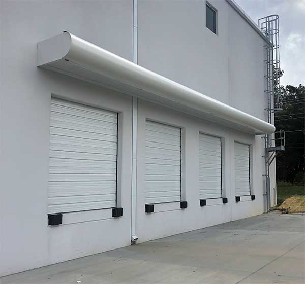 Canopy overhanging loading doors and bumpers