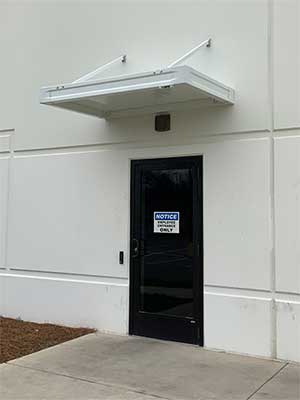 White canopy over a black door.