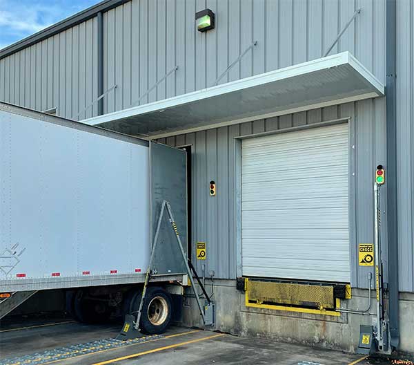 Loading dock with one truck and a door.